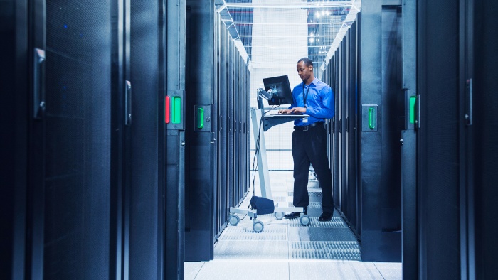 Businessman using computer in server room