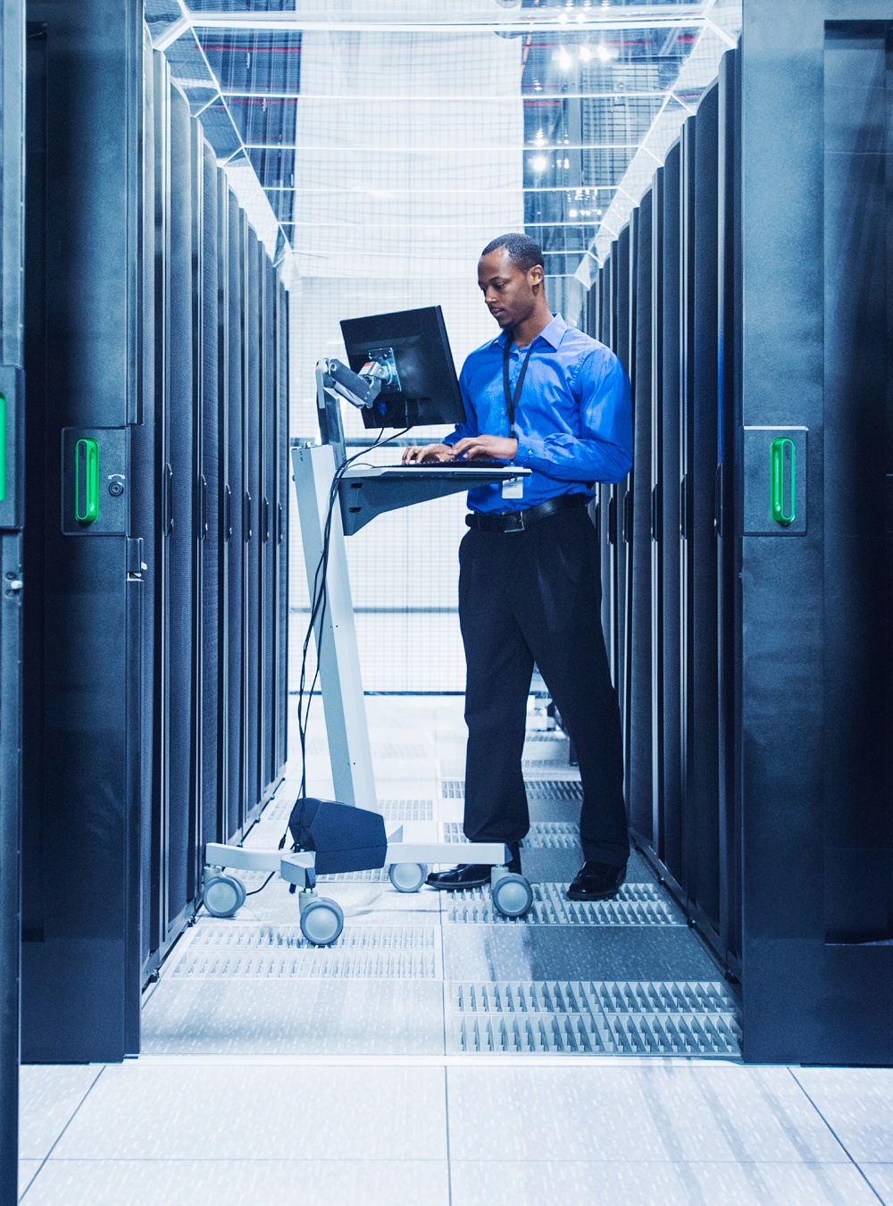 Businessman using computer in server room