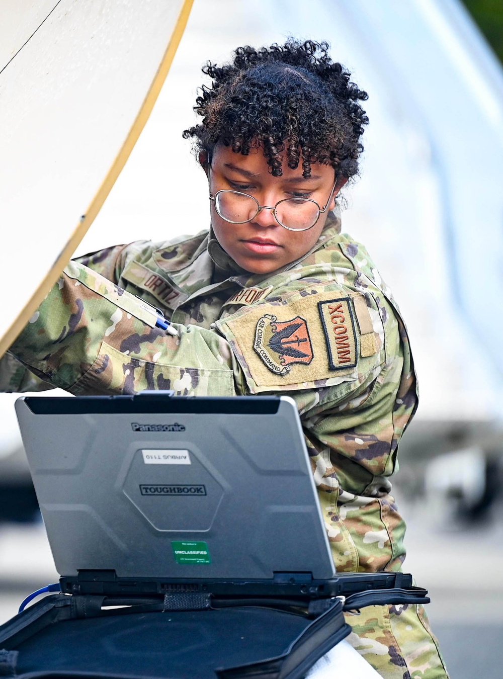Air Force Airman 1st Class Rashin Ortiz aligns a satellite during Bamboo Eagle
