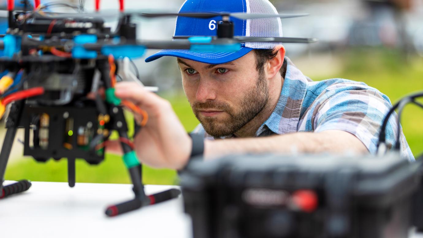 Employee holding a drone