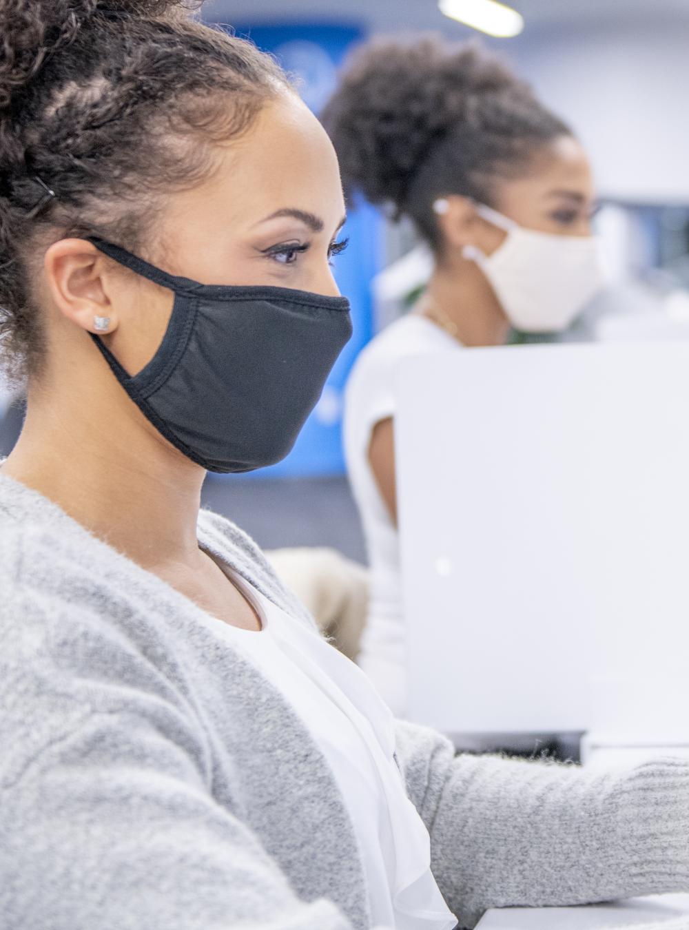 College students in masks working in a lab