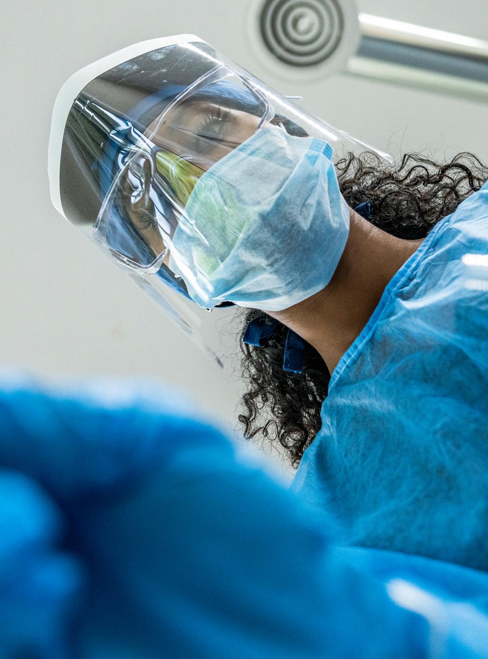 Clinician wearing goggles, mask, and face shield