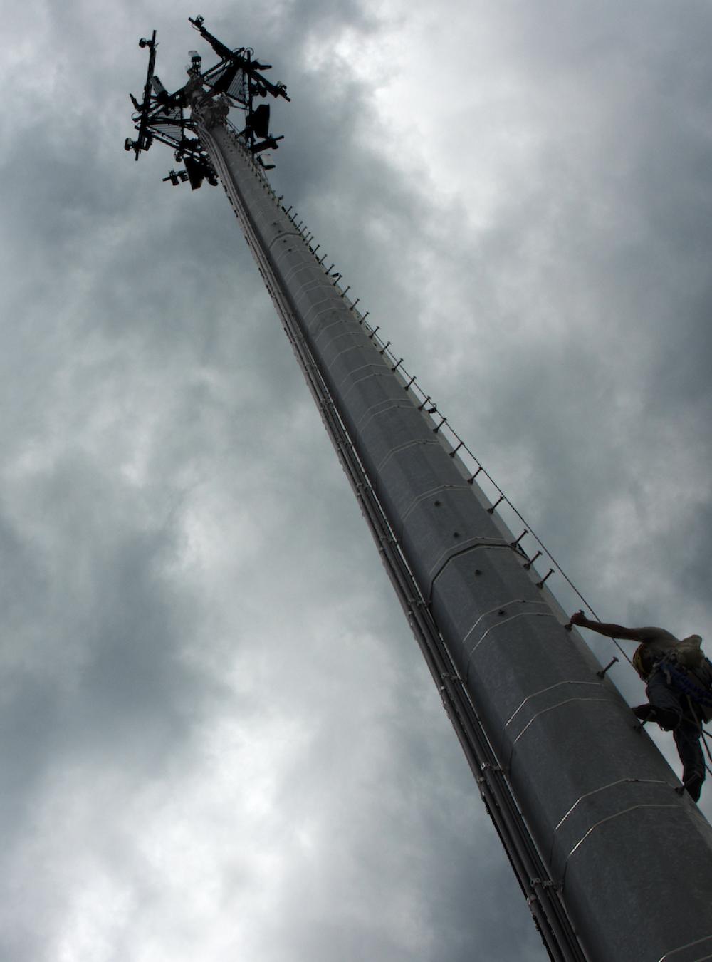 5G tower with a stormy sky behind it