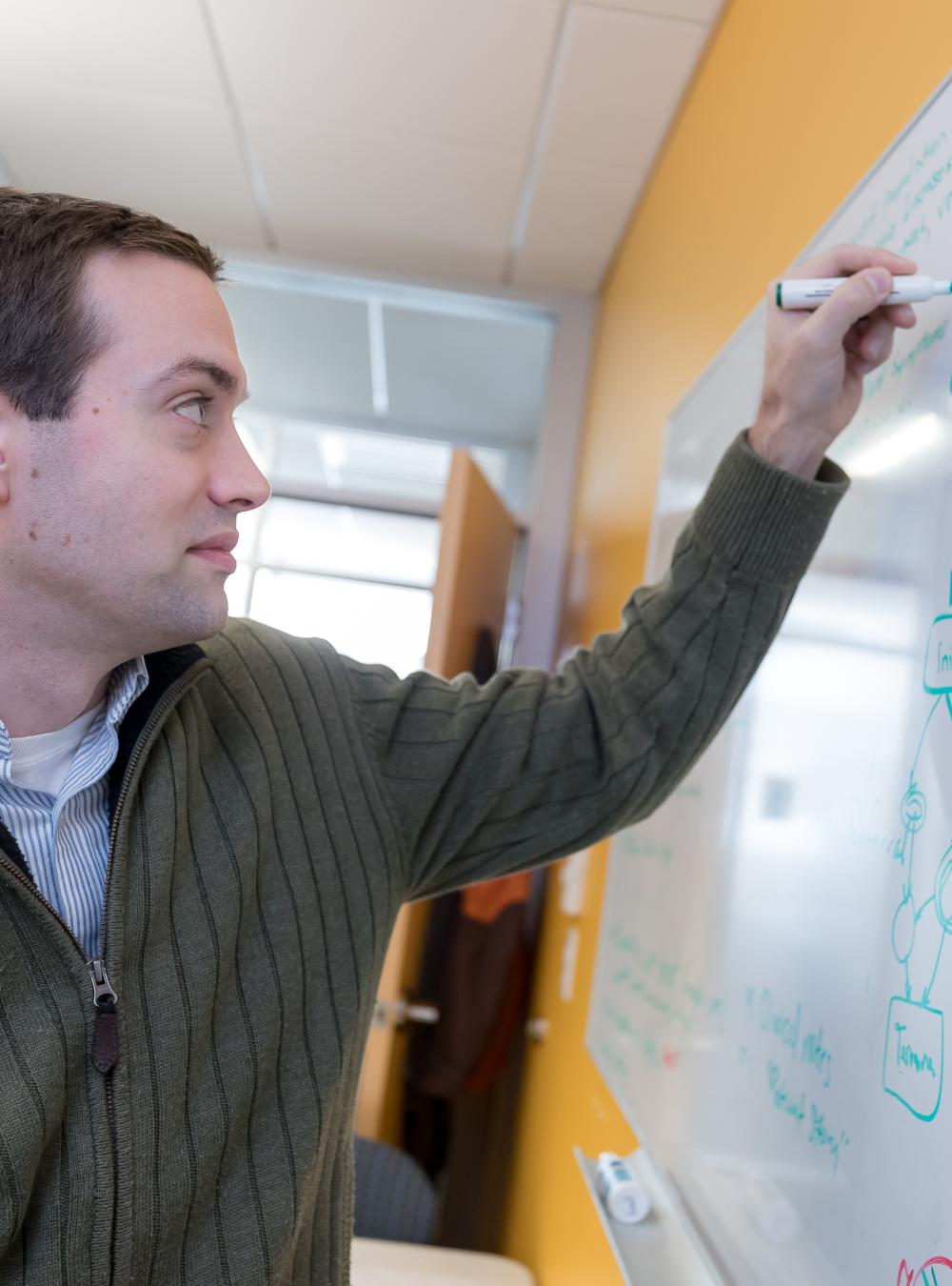 Jason Walonoski writing on a whiteboard