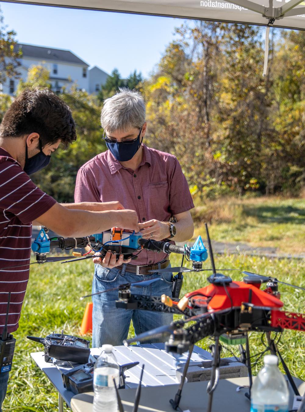 Project team with aerial and ground robots during an intelligence, surveillance, and reconnaissance demo