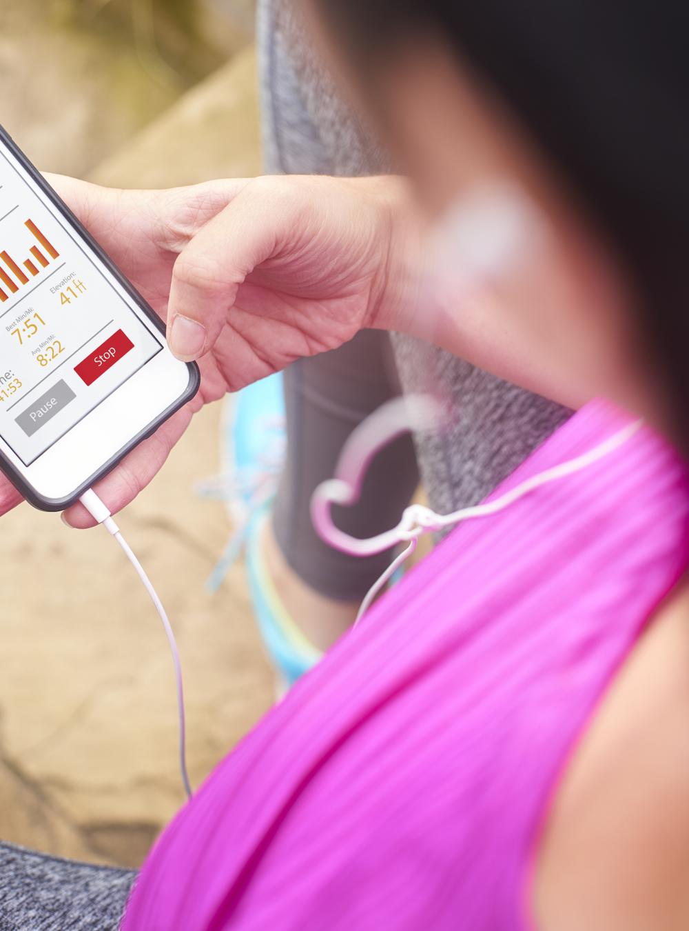 Runner monitoring her health on her phone