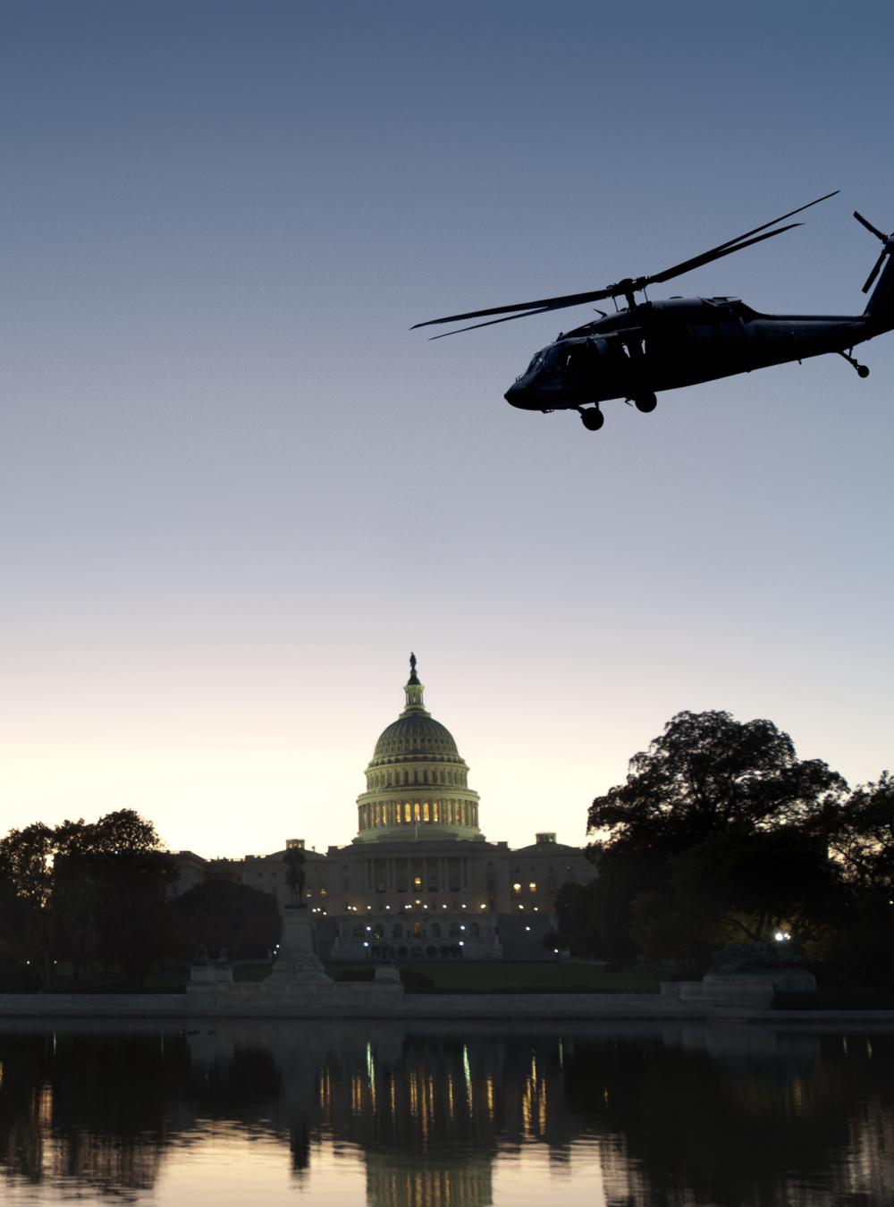 Security team with U.S. Capitol in in the background and helicopter flying by