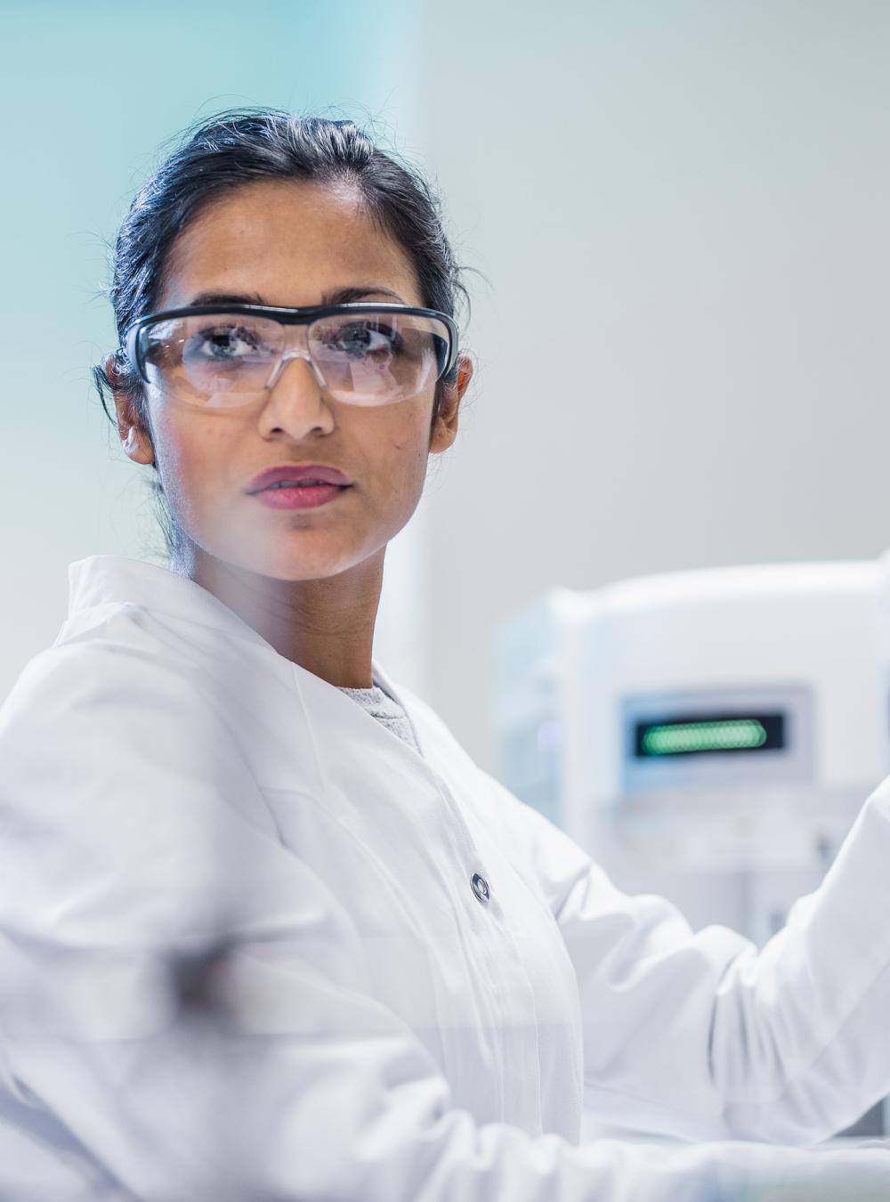 Female scientist using a touchscreen computer while working in a lab