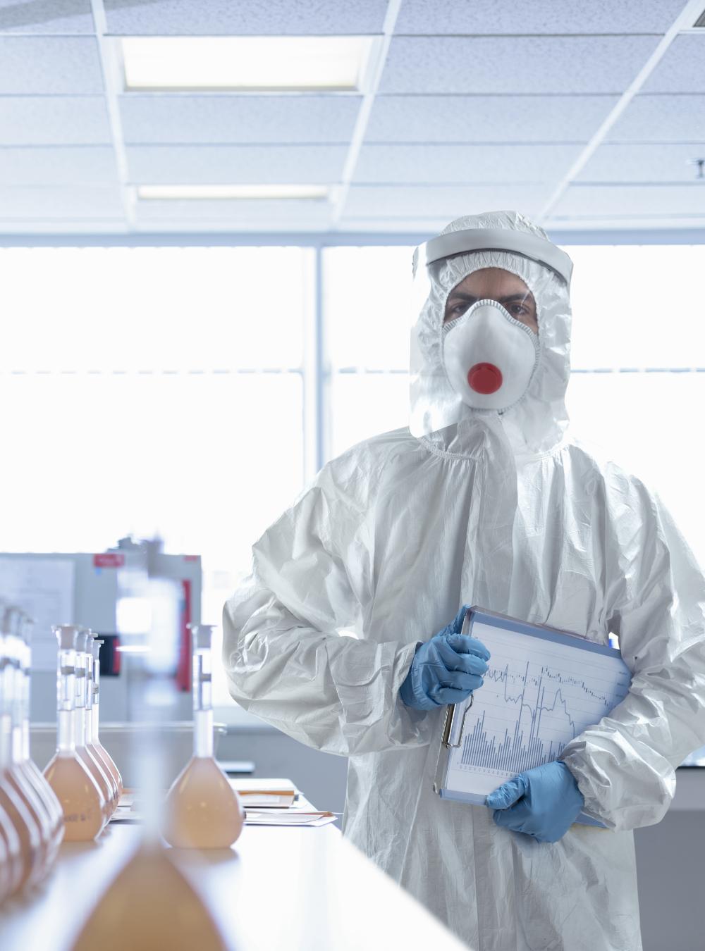 Scientist in a full-body protective suit in a biopharma lab