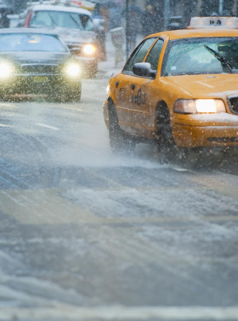 USA, New York, New York City, Traffic on street in snow