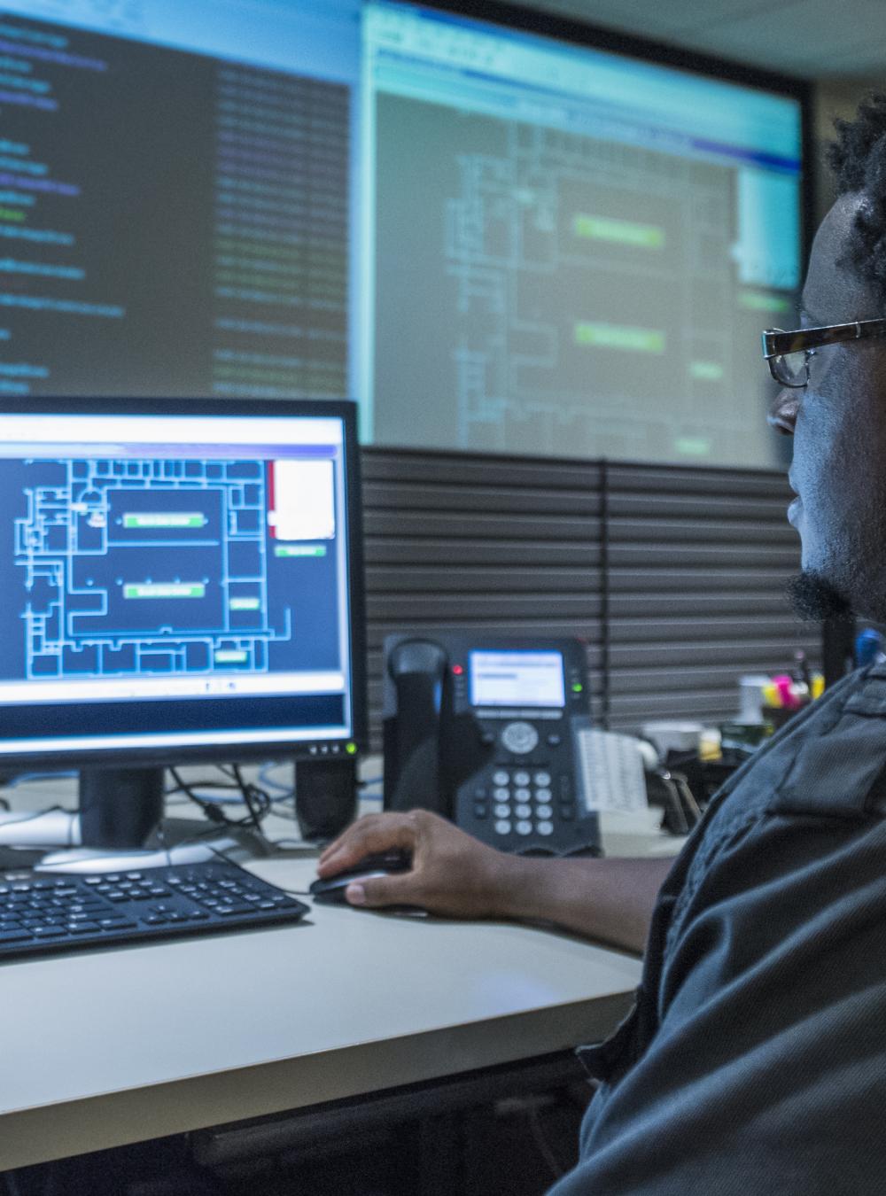 Man working at desk in server control room