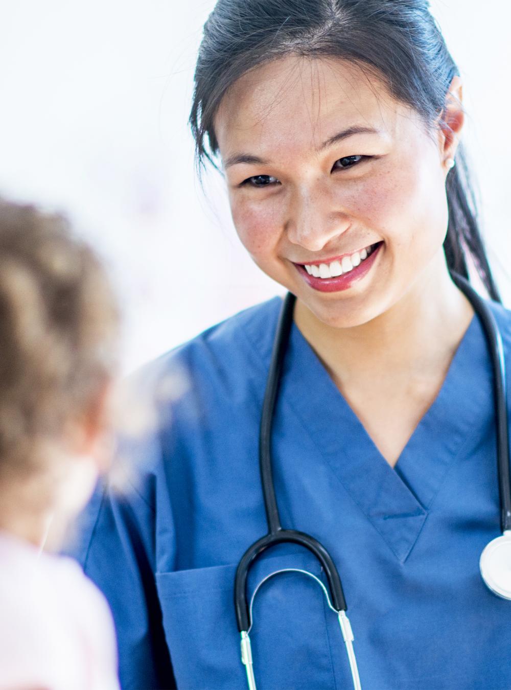 Female doctor smiling at a child