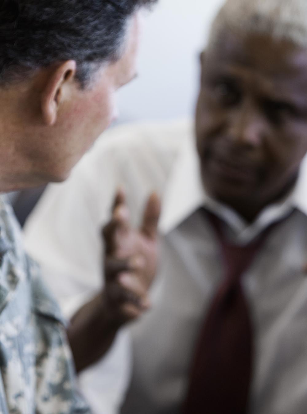 Military officer speaking holding a meeting with businessman