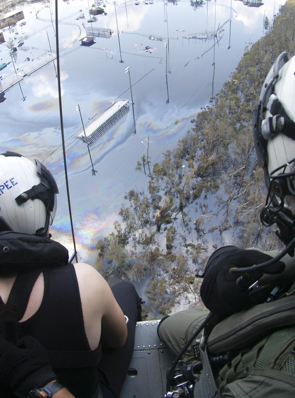 A Search and Rescue (SAR) swimmer assigned to Helicopter Sea Combat Squadron Two Eight (HSC-28), prepare to assist in a rescue of a Hurricane Katrina survivor in Louisiana