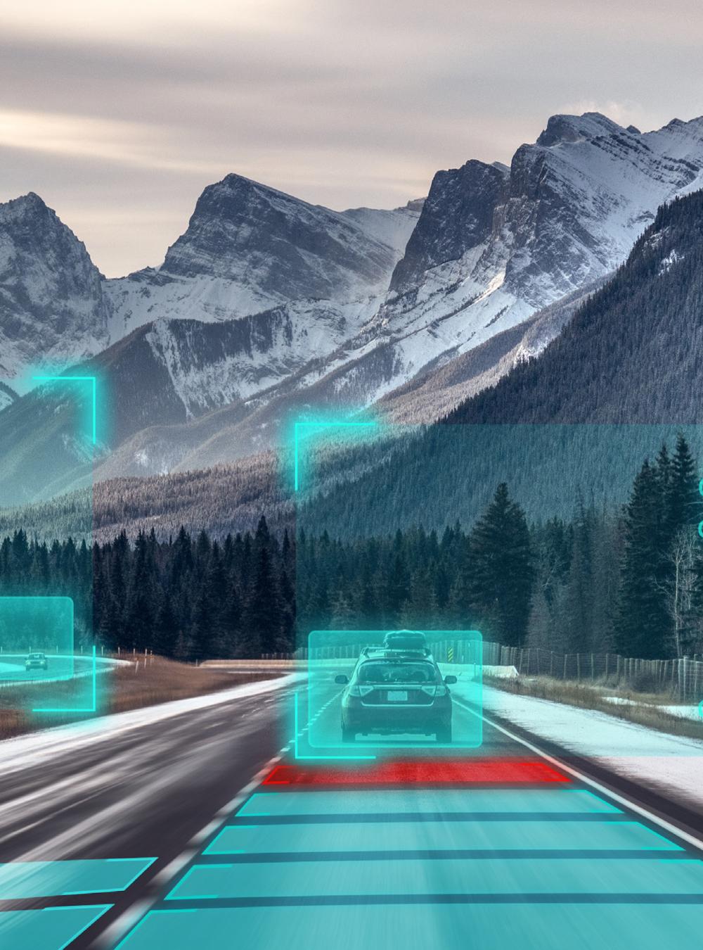 Automated vehicles driving on a road near a snowy mountain range