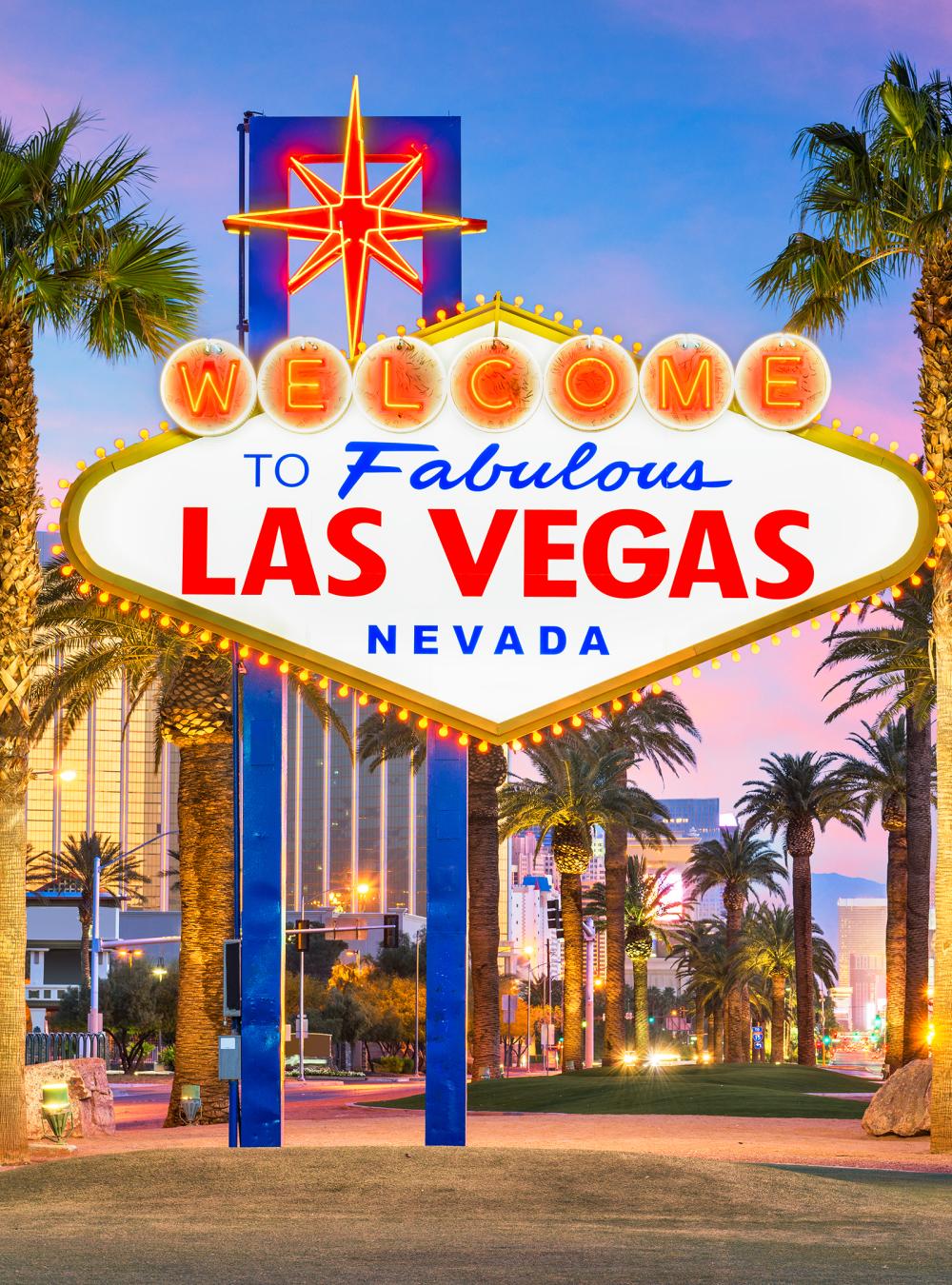 The Las Vegas Nevada sign with buildings and palm trees behind it