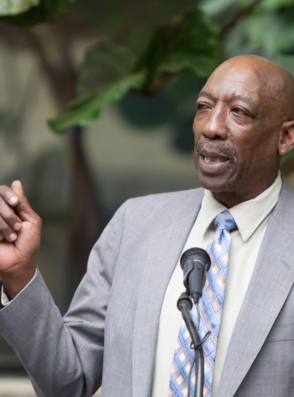 Booker Brown speaking at a podium