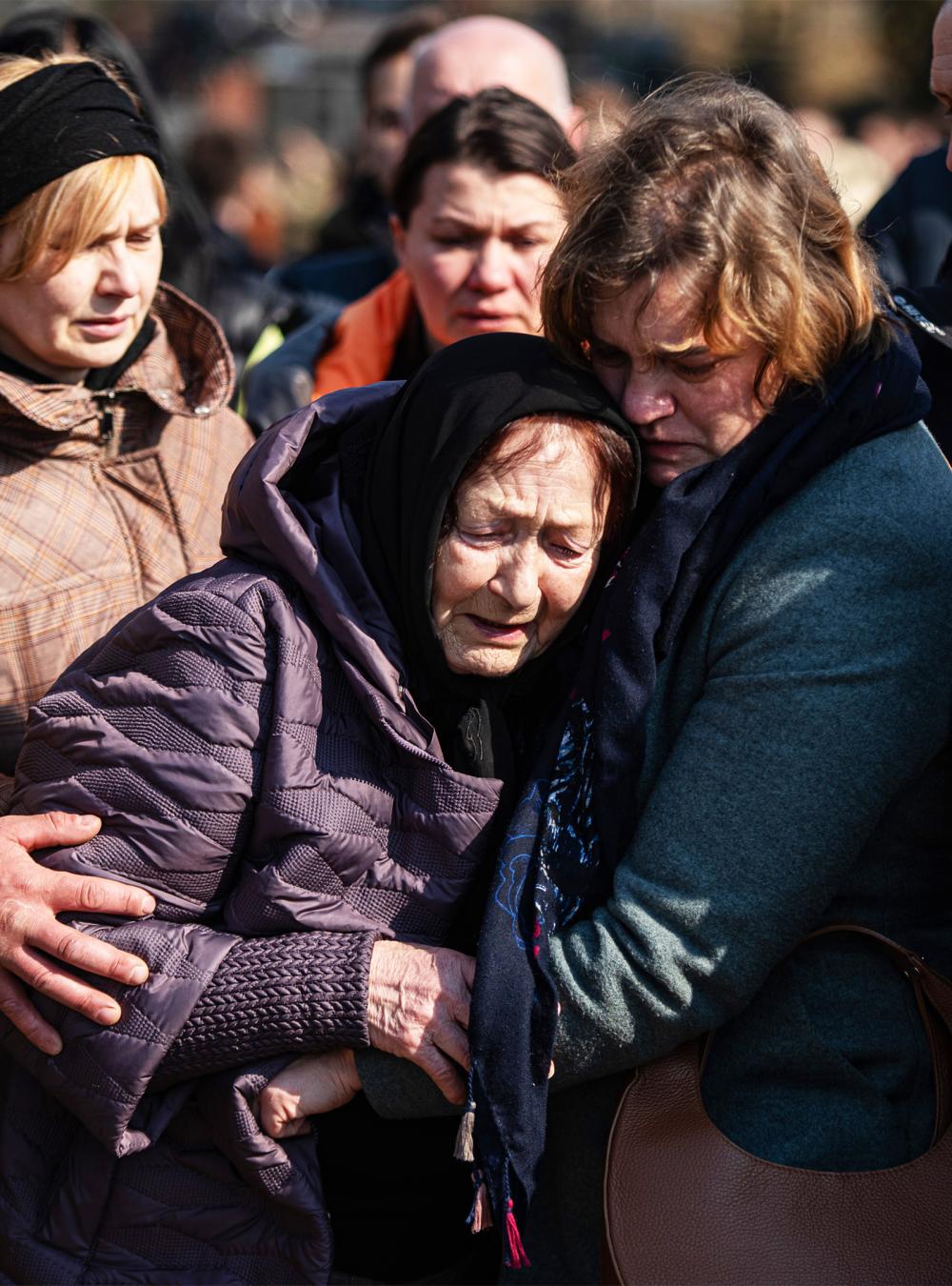 Ukrainians mourning at a funeral for soldier