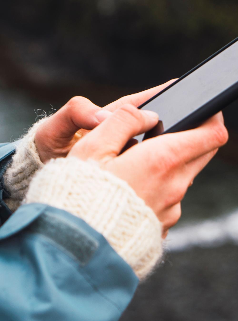 Hands of a woman holding a smartphone