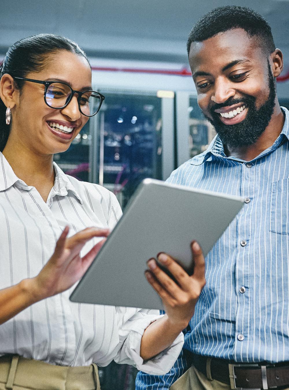 Two colleagues working together on a tablet