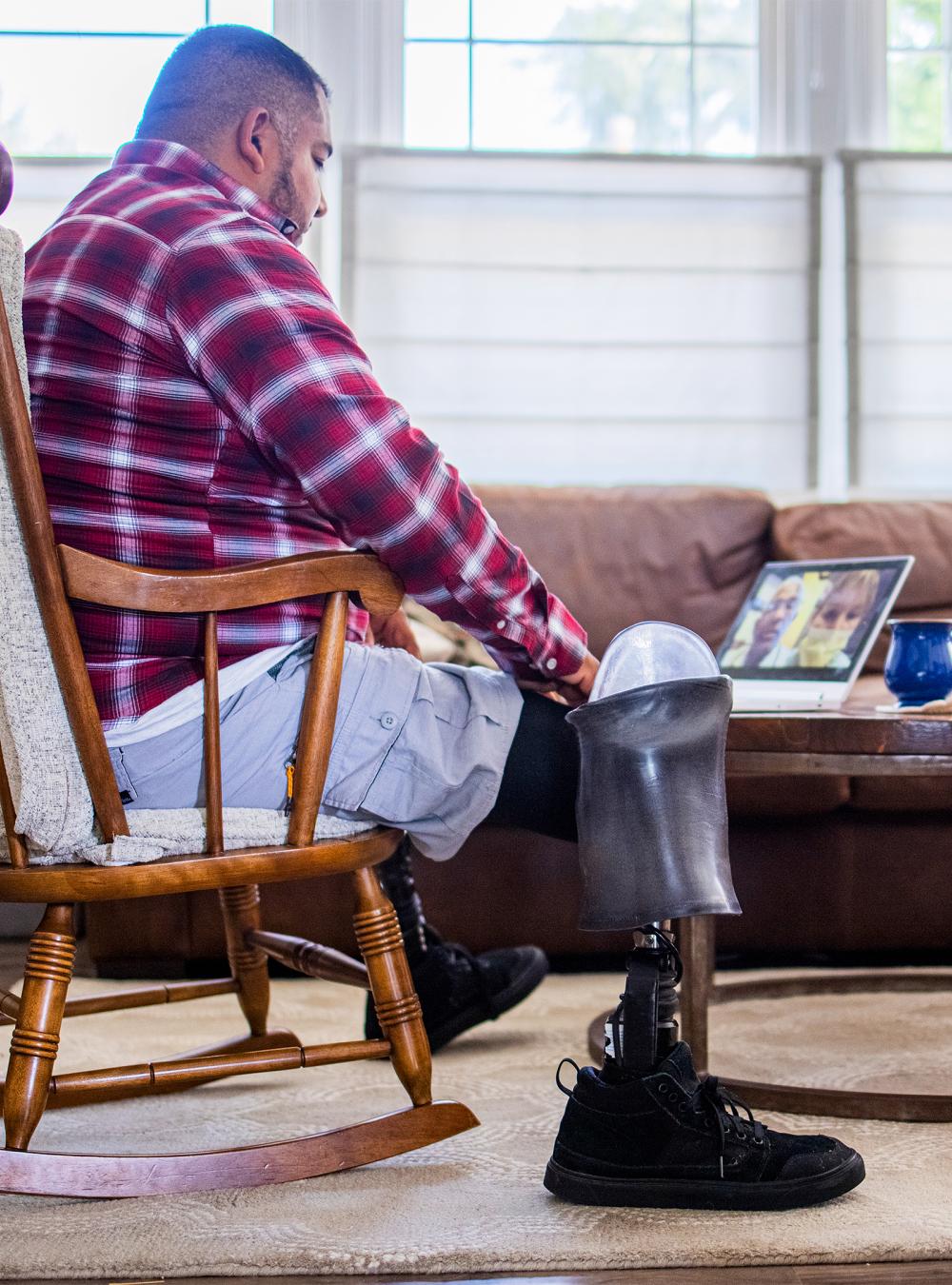 Veteran amputee has a telemedicine call with doctors