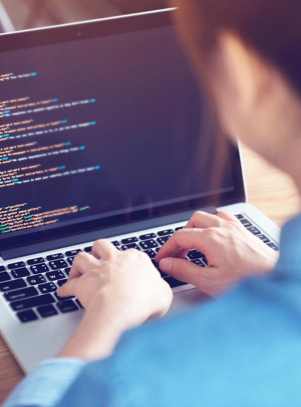 Woman hands coding html and programming on screen laptop