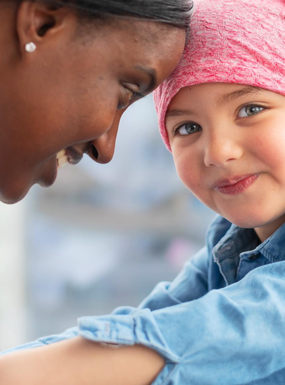 Female doctor comforts her young patient who has cancer