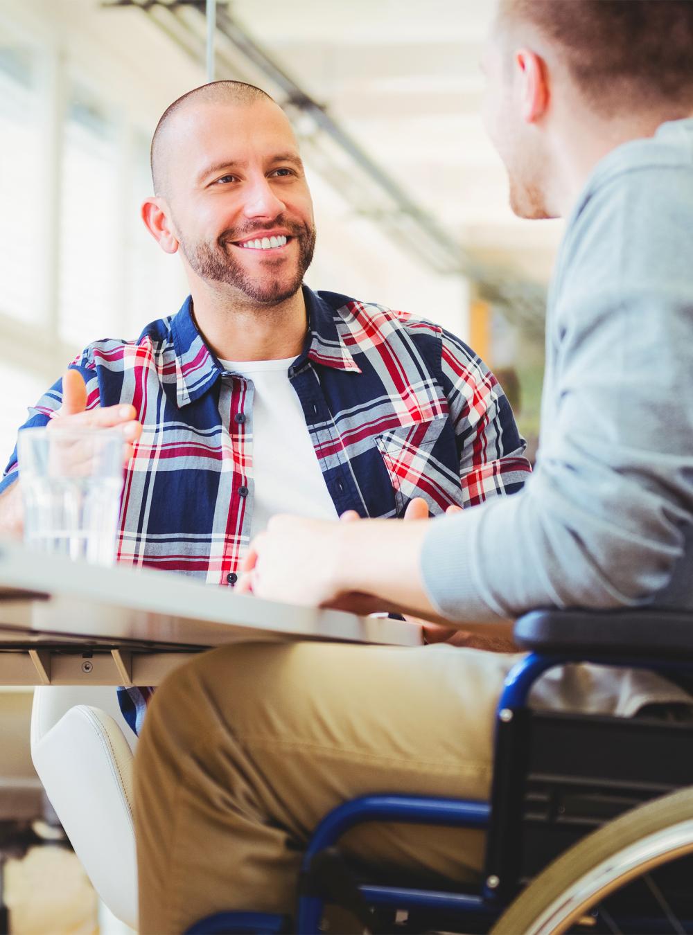 Handicap businessman sitting with colleague in the office