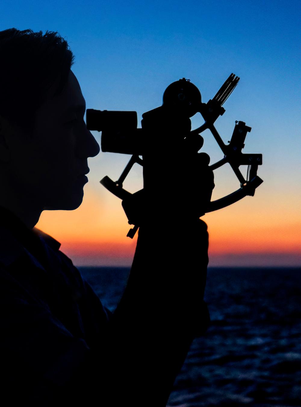 Man looking through sextant