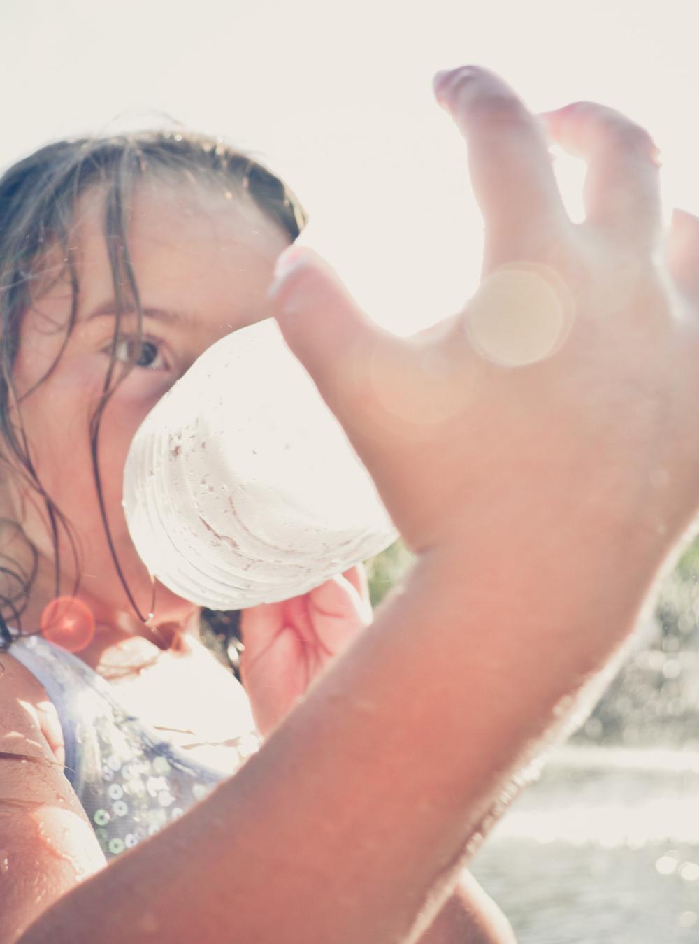 girl drinking from a water bottle