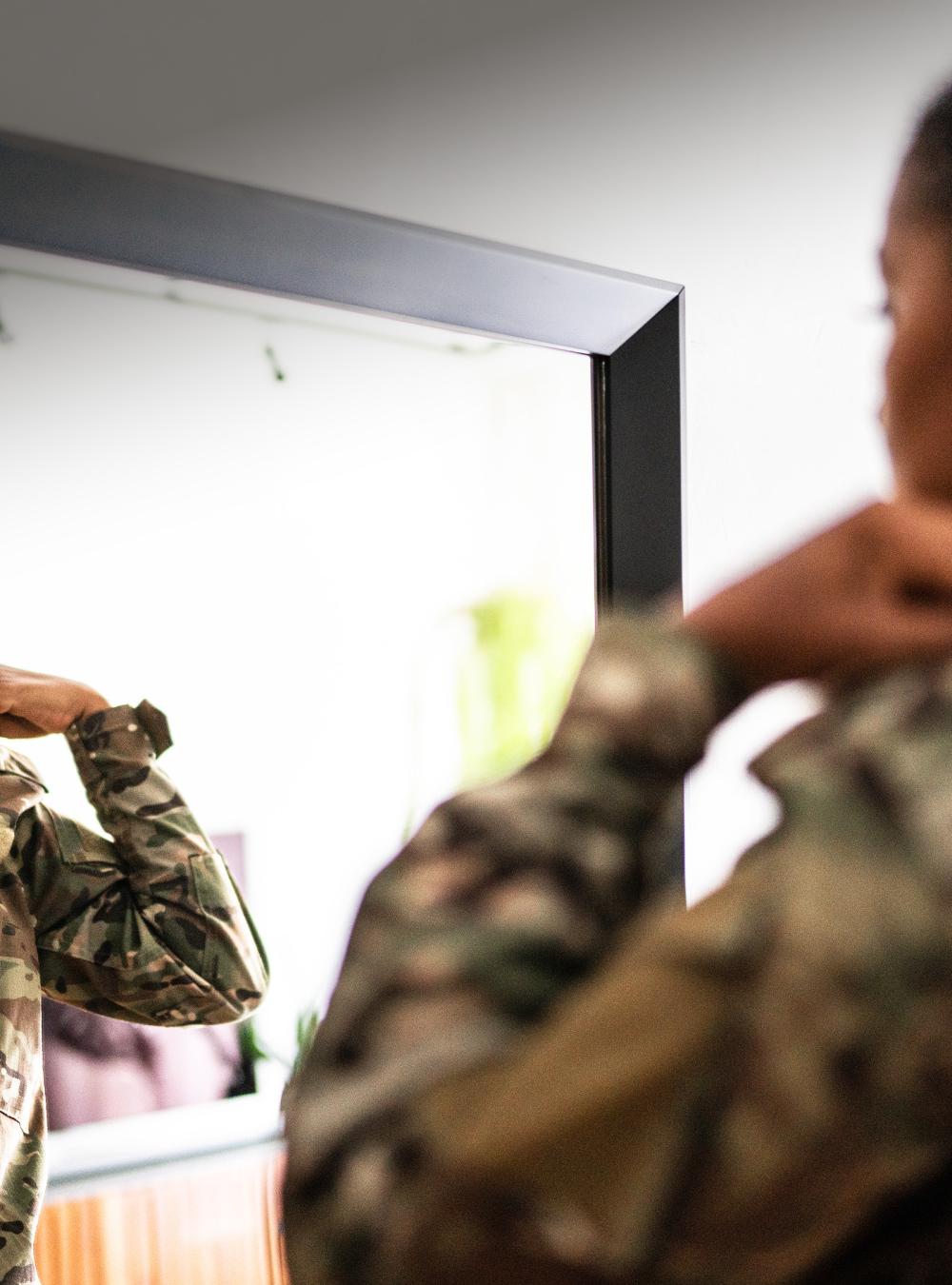 female soldier in front of a mirror