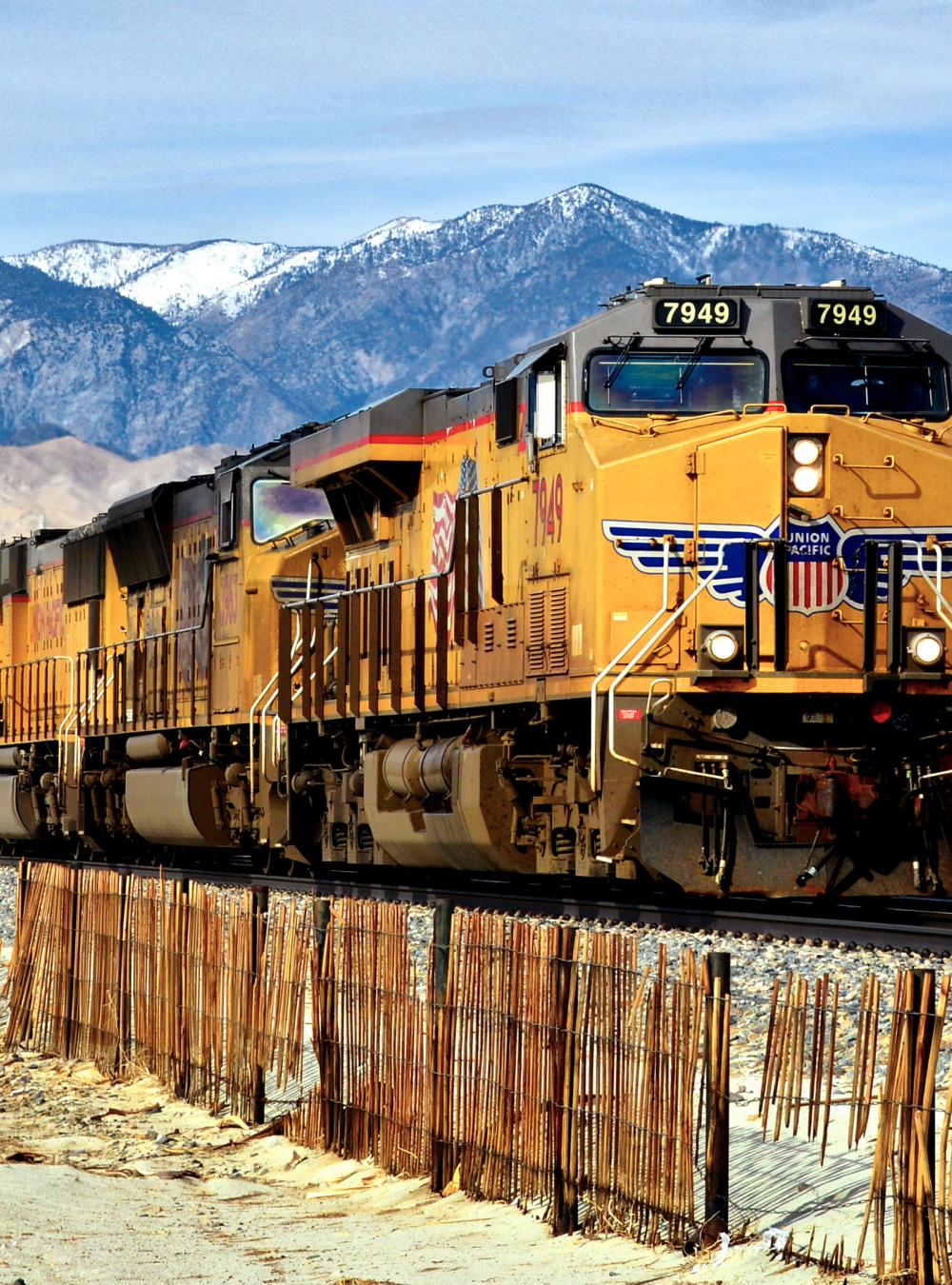 train in front of mountains