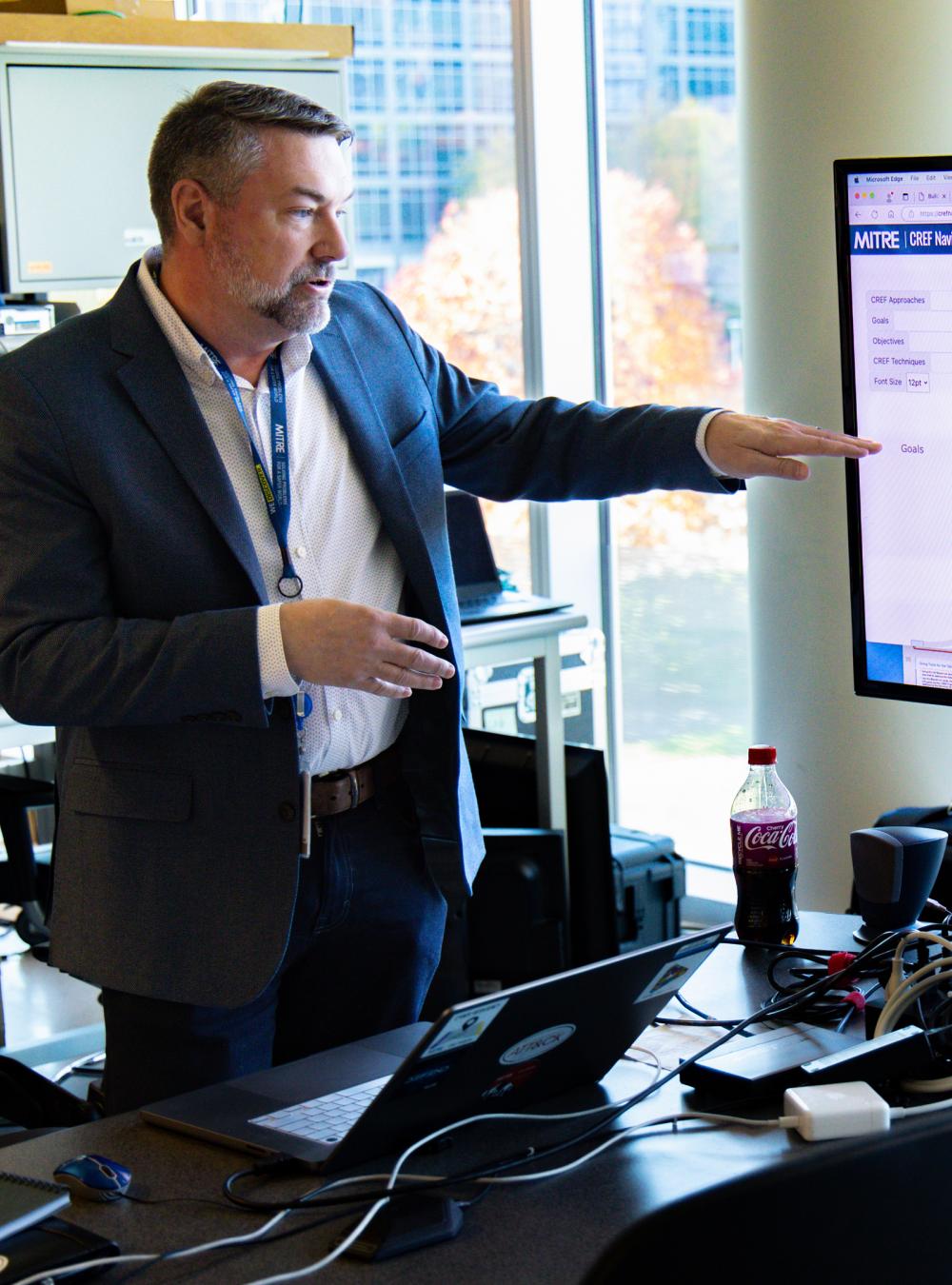 Man showing a relationship diagram on a computer screen