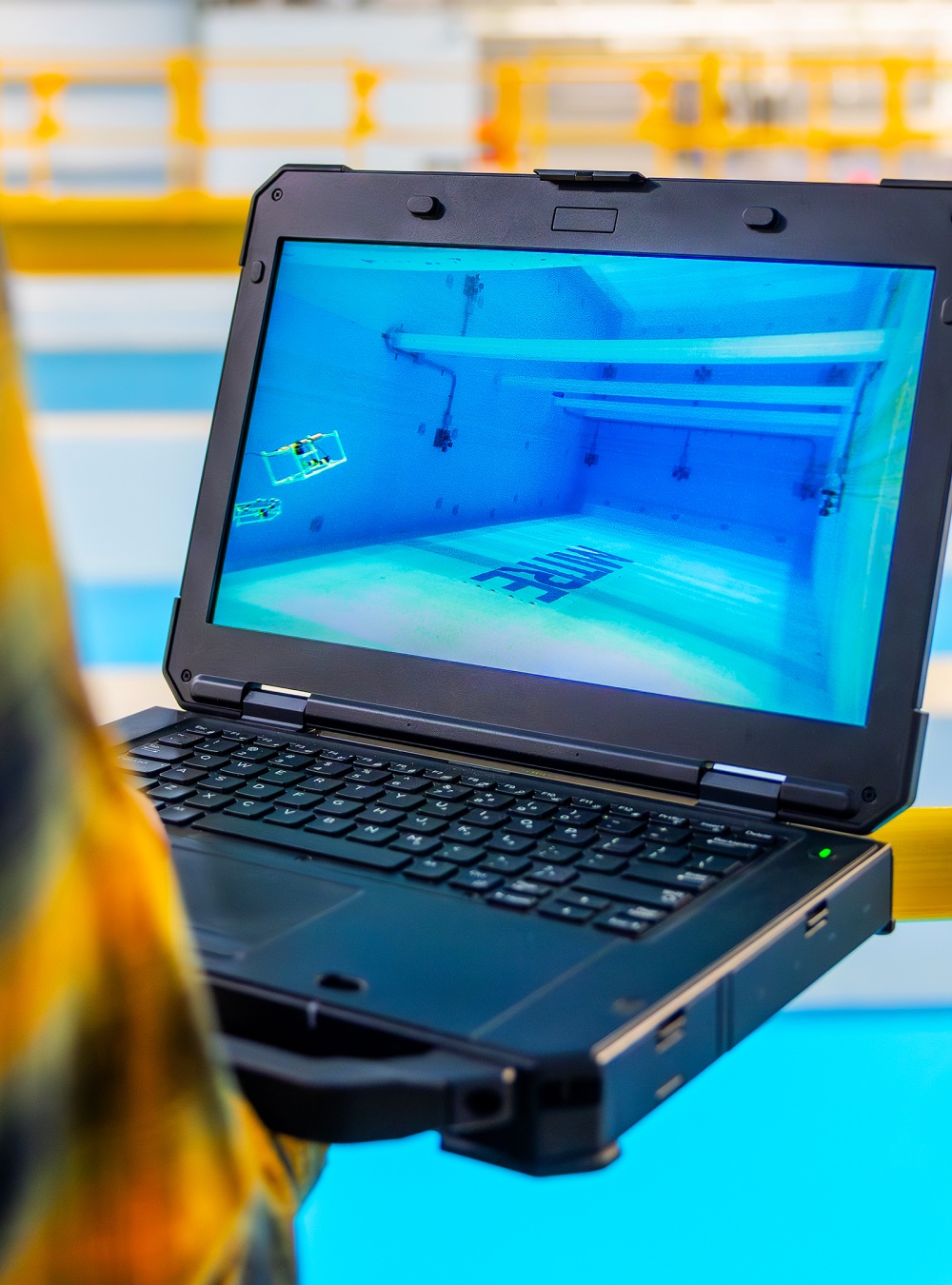 Employee holding a laptop in the BlueTech lab