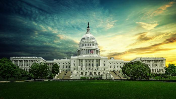 Capitol building framed by a dramatic sky