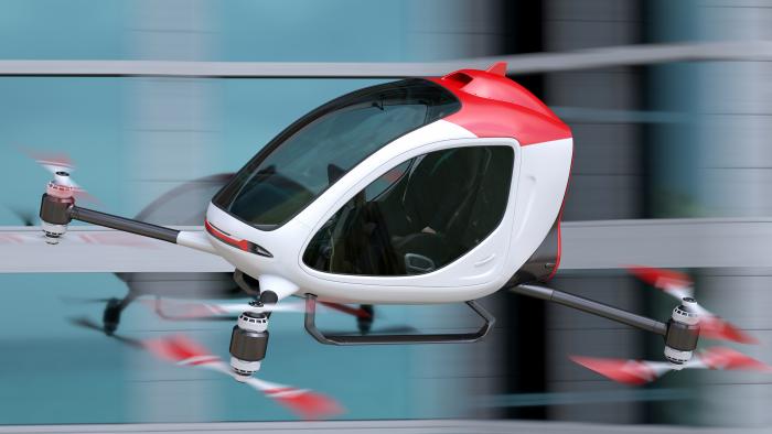 Air Taxi speeding past a building