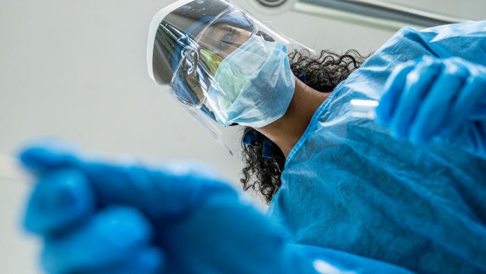 Clinician wearing goggles, mask, and face shield