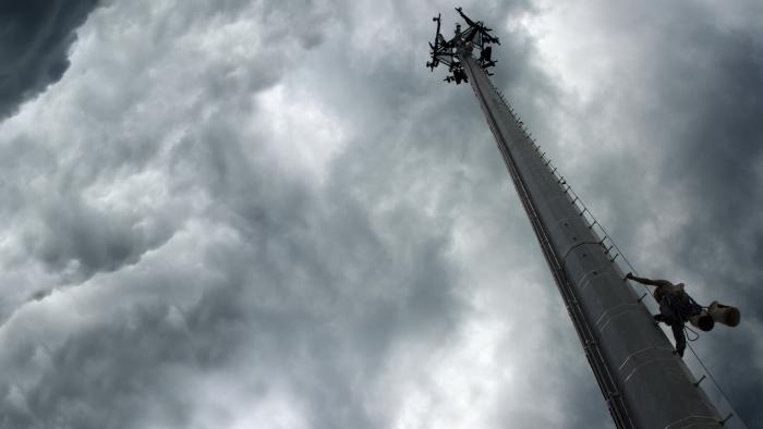 5G tower with a stormy sky behind it