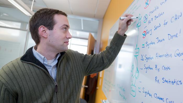 Jason Walonoski writing on a whiteboard