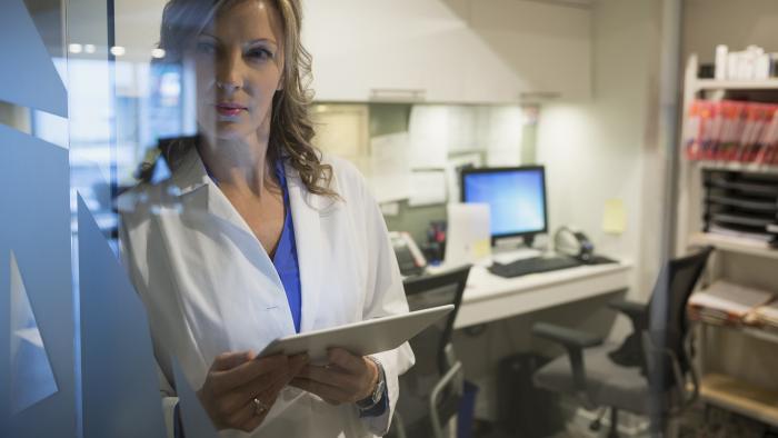 Doctor holing a tablet conducting medical research