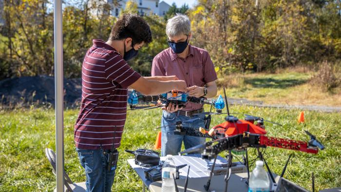 Project team with aerial and ground robots during an intelligence, surveillance, and reconnaissance demo