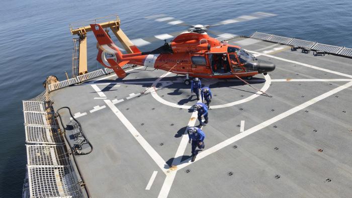 Coast Guard helicopter about to take off from a ship