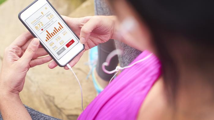 Runner monitoring her health on her phone