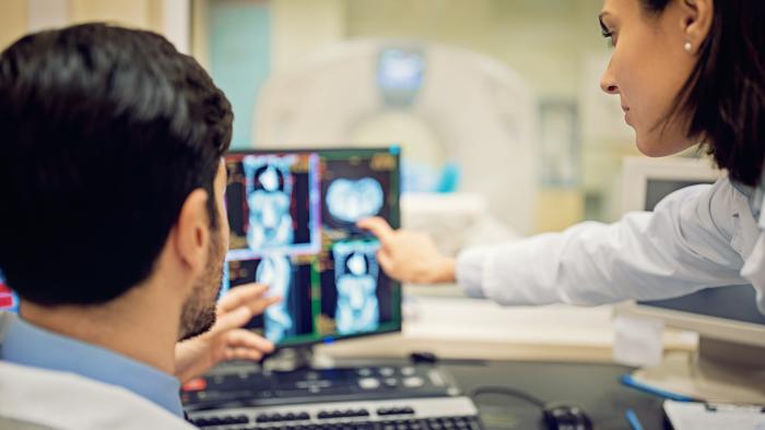 Doctors looking at medical data on a screen together