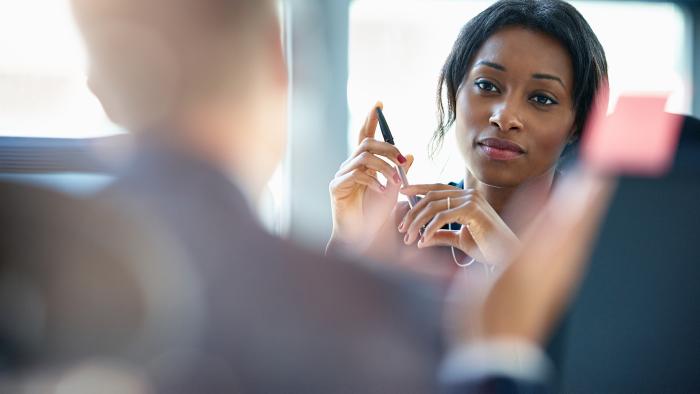 Businesswomen discussing plans with a colleague