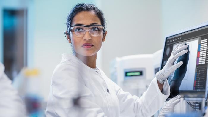 Female scientist using a touchscreen computer while working in a lab