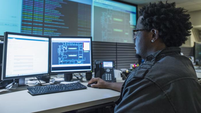 Man working at desk in server control room