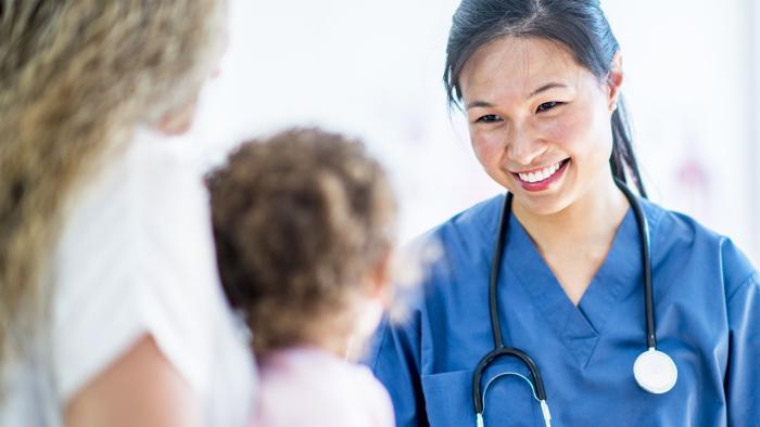 Female doctor smiling at a child