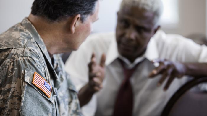 Military officer speaking holding a meeting with businessman