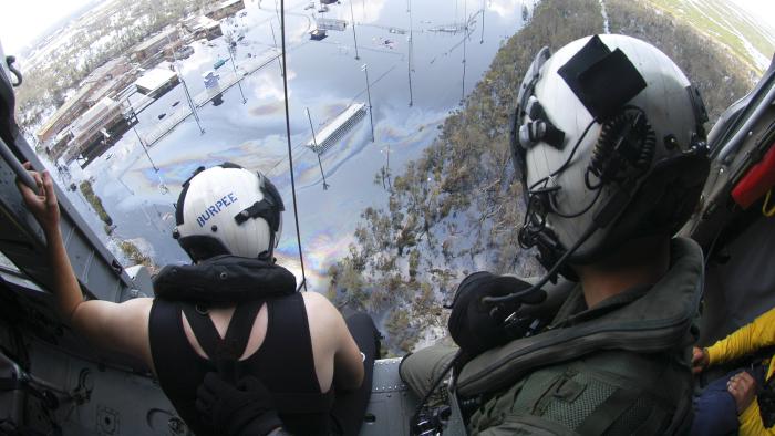 A Search and Rescue (SAR) swimmer assigned to Helicopter Sea Combat Squadron Two Eight (HSC-28), prepare to assist in a rescue of a Hurricane Katrina survivor in Louisiana